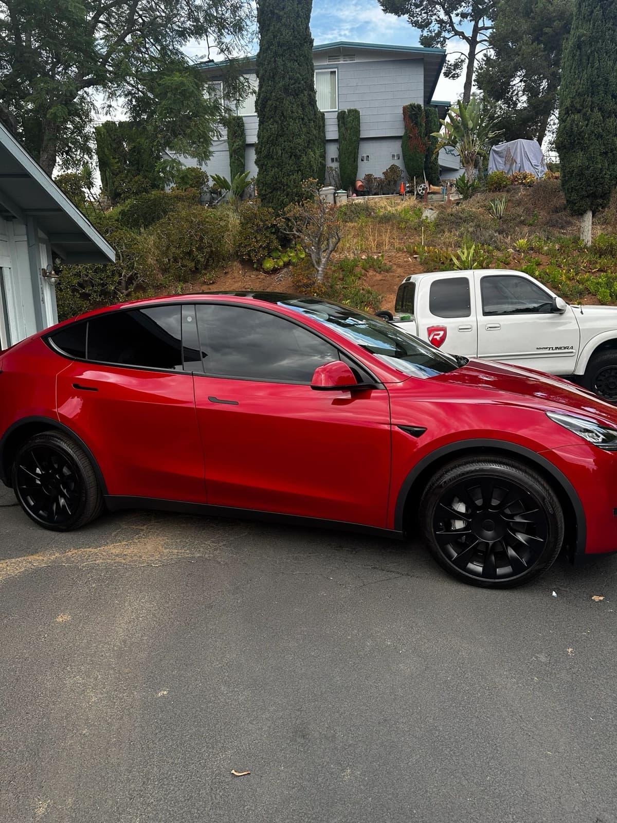 Red Tesla Model Y detailed in a residential driveway